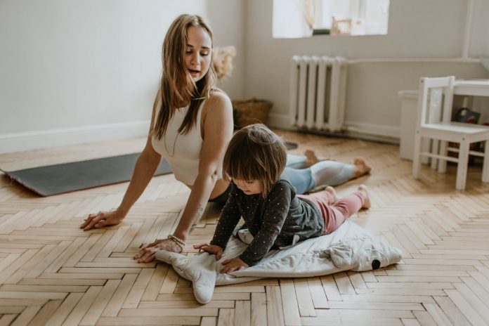 A woman stretching with her daughter